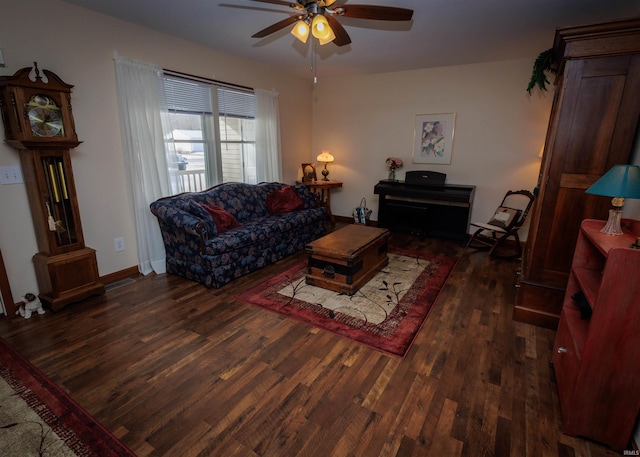 living area featuring dark wood-style floors, visible vents, baseboards, and a ceiling fan