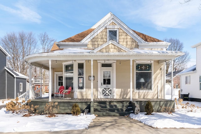 view of front of property with covered porch and a shingled roof