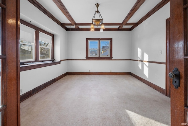 empty room with coffered ceiling, light carpet, beamed ceiling, and baseboards