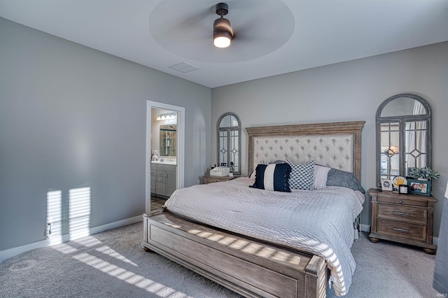 bedroom featuring visible vents, light carpet, ceiling fan, ensuite bath, and baseboards