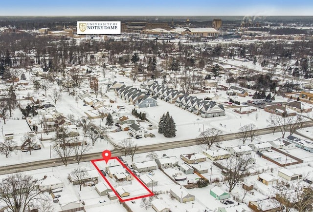 snowy aerial view with a residential view