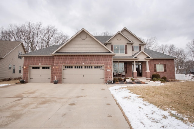 craftsman-style house featuring covered porch, driveway, brick siding, and an attached garage