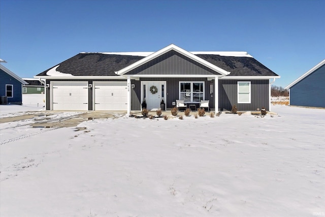 view of front of property featuring a shingled roof, central AC, and an attached garage