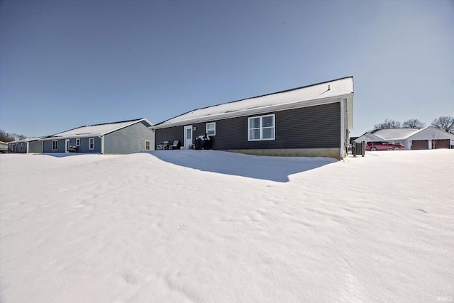 ranch-style house with a garage and central air condition unit