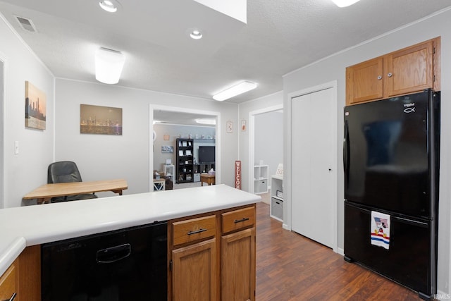 kitchen featuring dark wood finished floors, recessed lighting, light countertops, brown cabinetry, and black appliances