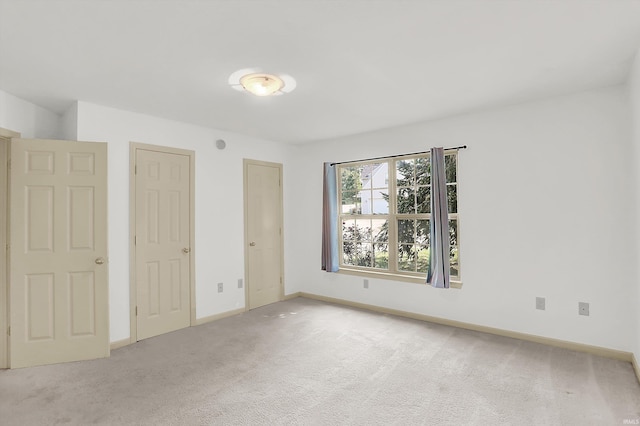 unfurnished bedroom with carpet floors and baseboards