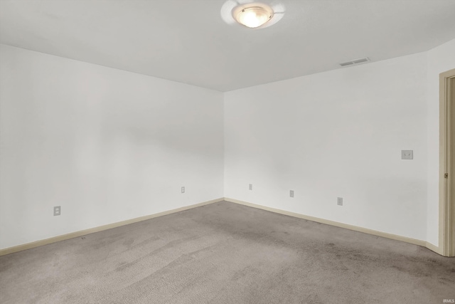 carpeted empty room featuring visible vents and baseboards