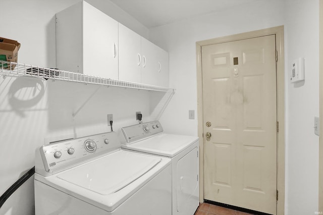washroom with washer and dryer, cabinet space, and light tile patterned flooring