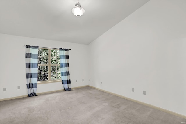 unfurnished room with baseboards and light colored carpet
