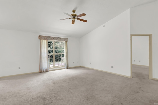 unfurnished room featuring baseboards, vaulted ceiling, and light colored carpet