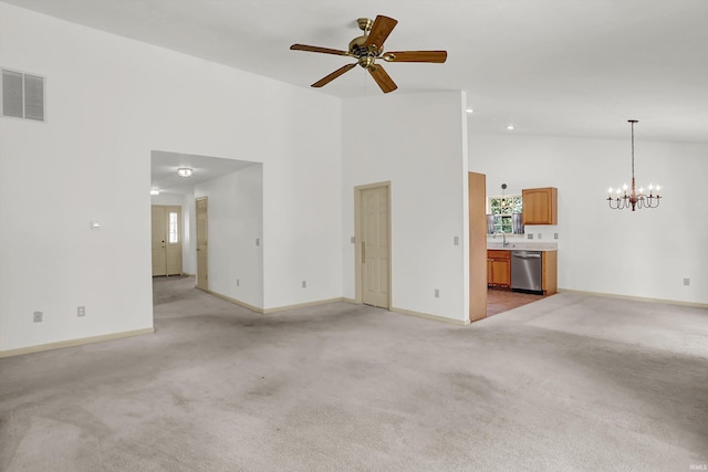 unfurnished living room featuring light colored carpet, visible vents, high vaulted ceiling, plenty of natural light, and baseboards