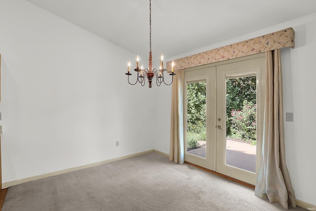 interior space featuring carpet floors, french doors, a chandelier, and baseboards