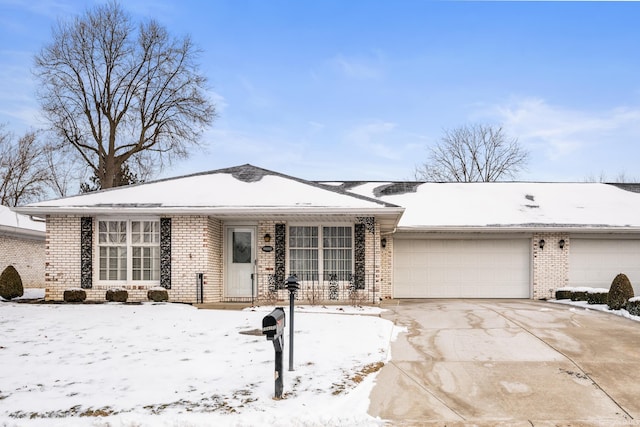 view of front facade with brick siding, driveway, and an attached garage