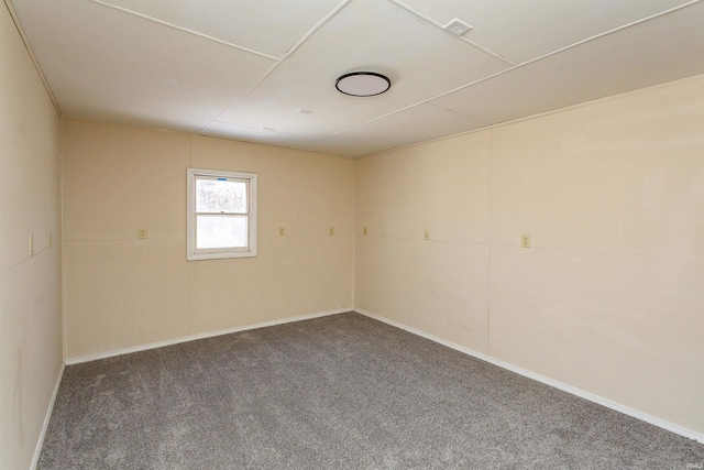 unfurnished room with carpet flooring and baseboards