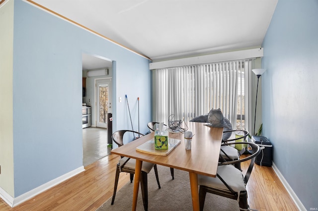 dining area with wood finished floors and baseboards