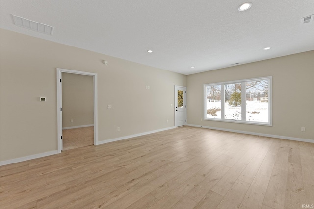 spare room featuring recessed lighting, visible vents, and light wood-style flooring