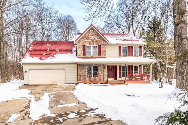 view of front of home featuring a porch, brick siding, driveway, and a garage