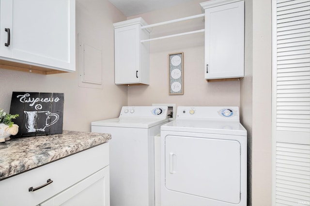 washroom with washing machine and dryer and cabinet space