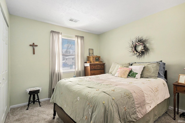 bedroom featuring light carpet, visible vents, and baseboards