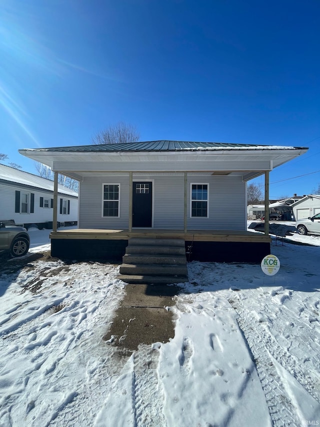 view of front of home with metal roof and a porch