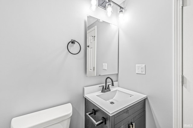 half bath with vanity and toilet