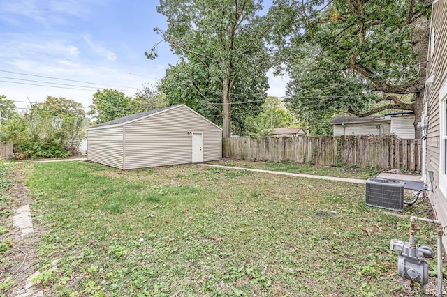 view of yard featuring fence, an outdoor structure, and central air condition unit