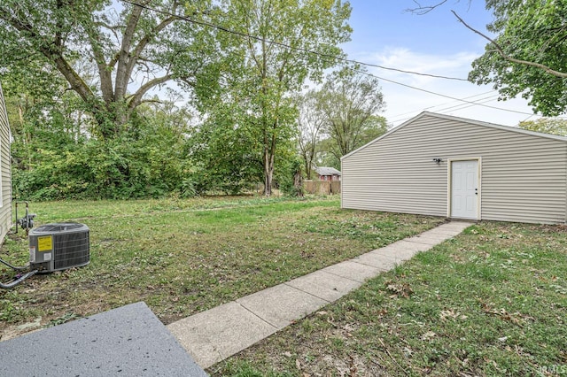 view of yard with central AC unit and fence