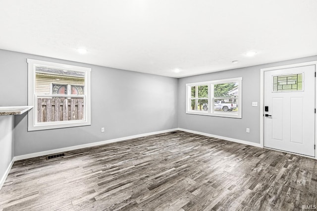 foyer featuring recessed lighting, visible vents, baseboards, and wood finished floors