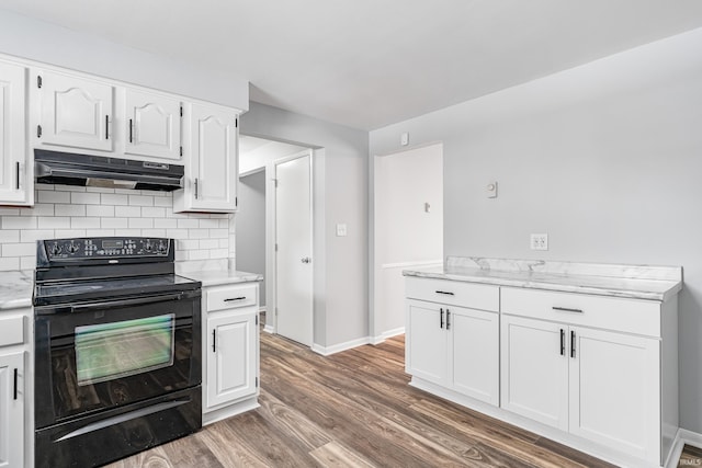 kitchen with white cabinets, dark wood-style flooring, black electric range, under cabinet range hood, and backsplash