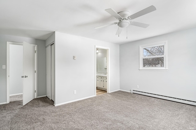 unfurnished bedroom with light carpet, a baseboard radiator, ensuite bath, and baseboards