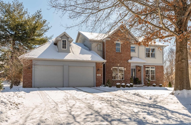 traditional-style home featuring a garage and brick siding