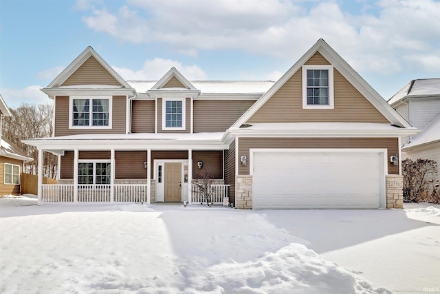 view of front of house featuring a garage, stone siding, and a porch