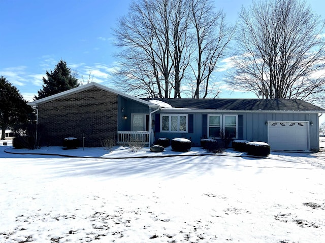 single story home featuring a garage, brick siding, and board and batten siding