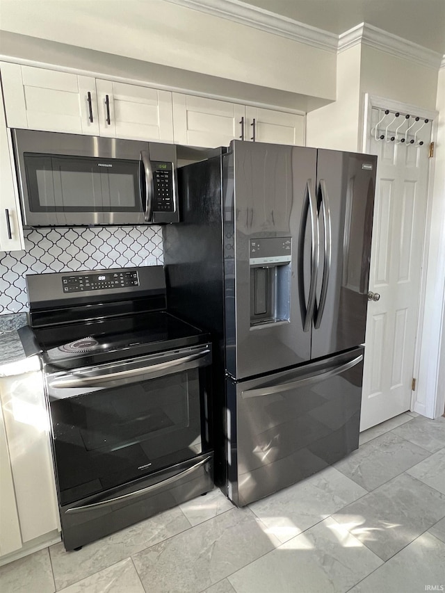 kitchen featuring tasteful backsplash, appliances with stainless steel finishes, white cabinetry, and ornamental molding