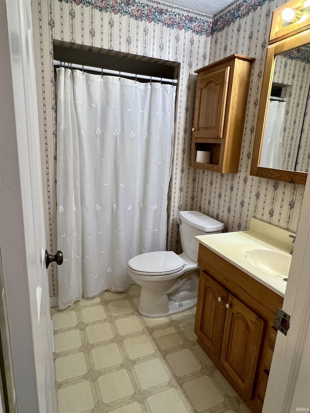 full bathroom with toilet, tile patterned floors, vanity, and wallpapered walls