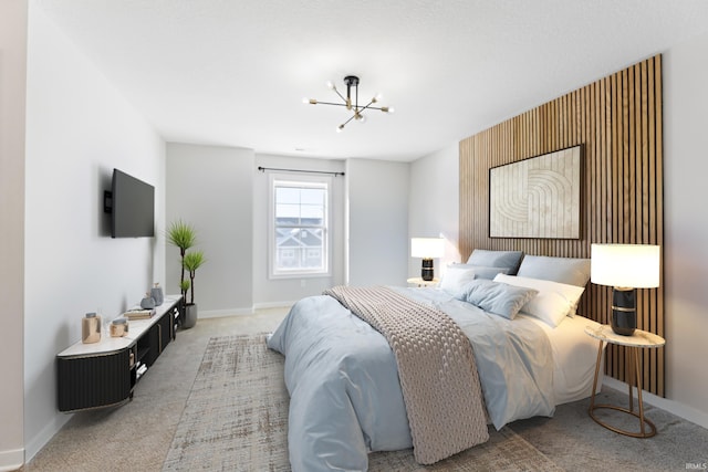 carpeted bedroom featuring a chandelier and baseboards