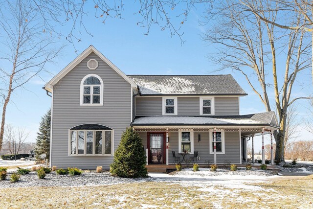 view of front of house with covered porch and roof with shingles