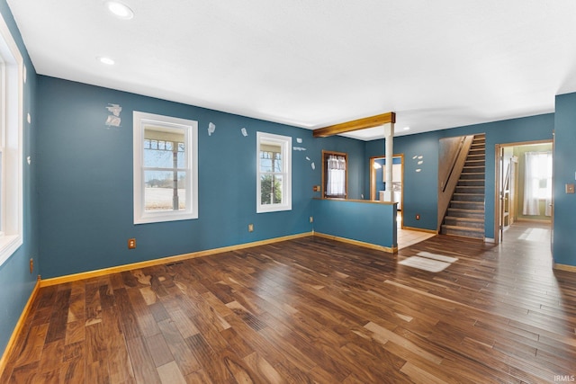 unfurnished living room with recessed lighting, dark wood-style flooring, baseboards, and stairs