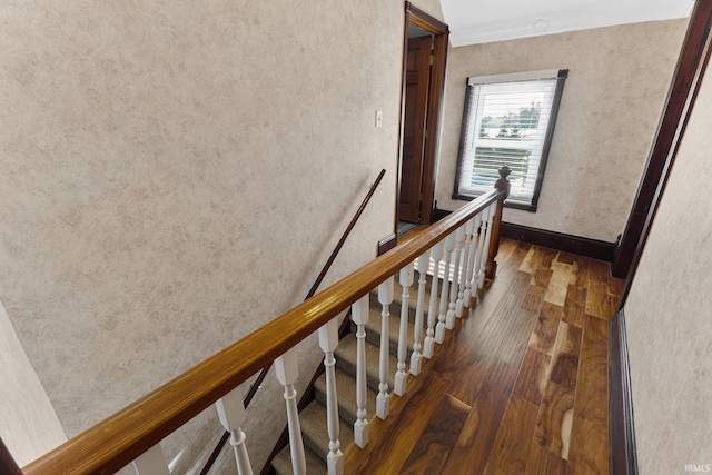 stairway featuring wood finished floors and baseboards