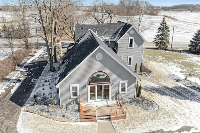 view of front facade with roof with shingles