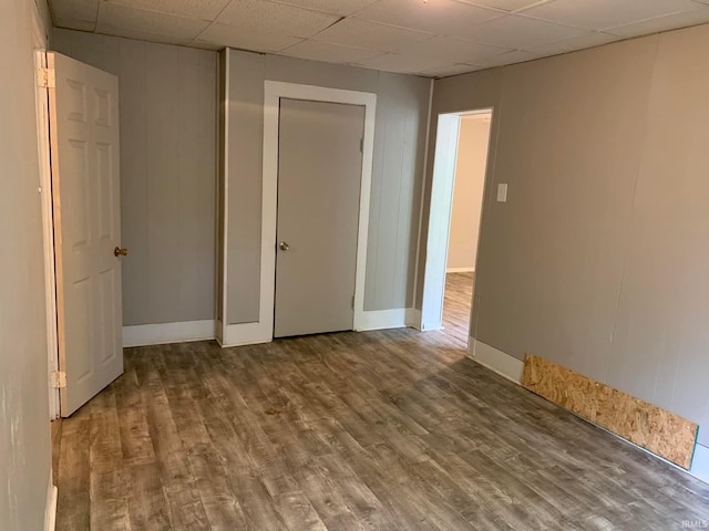 1419 Cumberland Ave, Evansville, IN 47712 - empty room featuring a drop ceiling, wood finished floors, and baseboards