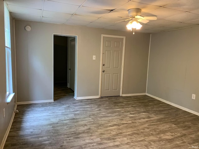 1419 Cumberland Ave, Evansville, IN 47712 - empty room with ceiling fan, a paneled ceiling, dark wood-style flooring, baseboards, and a wealth of natural light