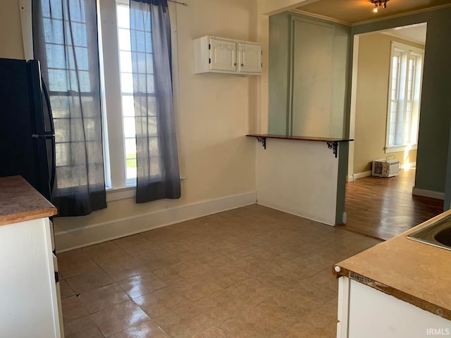 unfurnished dining area with baseboards