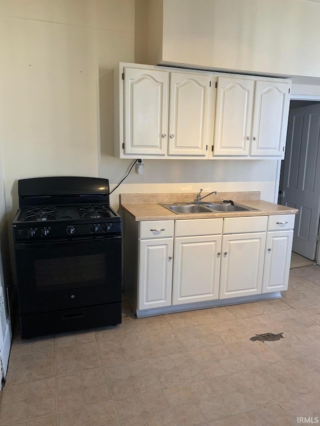 1419 Cumberland Ave, Evansville, IN 47712 - kitchen with white cabinets, light countertops, a sink, and black range with gas stovetop
