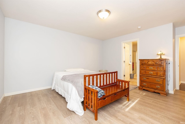 bedroom featuring light wood-style flooring and baseboards