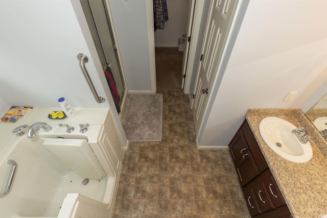 full bathroom with a stall shower, a garden tub, and vanity