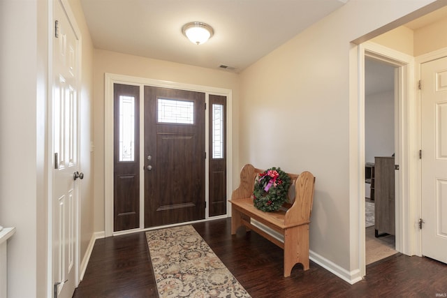 foyer featuring visible vents, baseboards, and wood finished floors