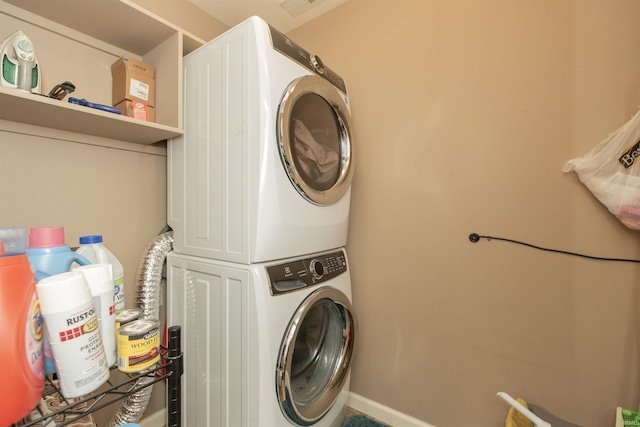 clothes washing area with laundry area and stacked washer / dryer