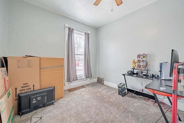 miscellaneous room featuring a ceiling fan, carpet flooring, a textured ceiling, and baseboards