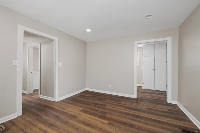 spare room with recessed lighting, dark wood-style flooring, and baseboards